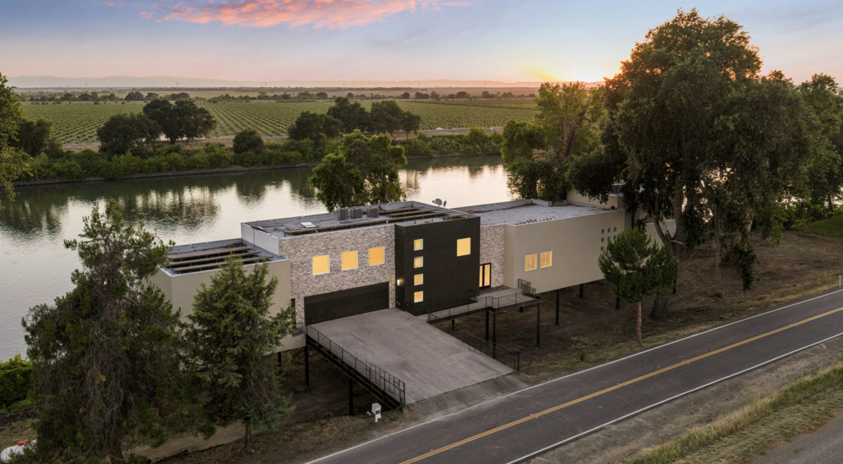 The front exterior view of a modern Sacramento River estate at 6301 Garden Highway in Sacramento. The 7,500-square-foot home is listed for $2.67 million and has five bedrooms and 5 1/2 bathrooms.